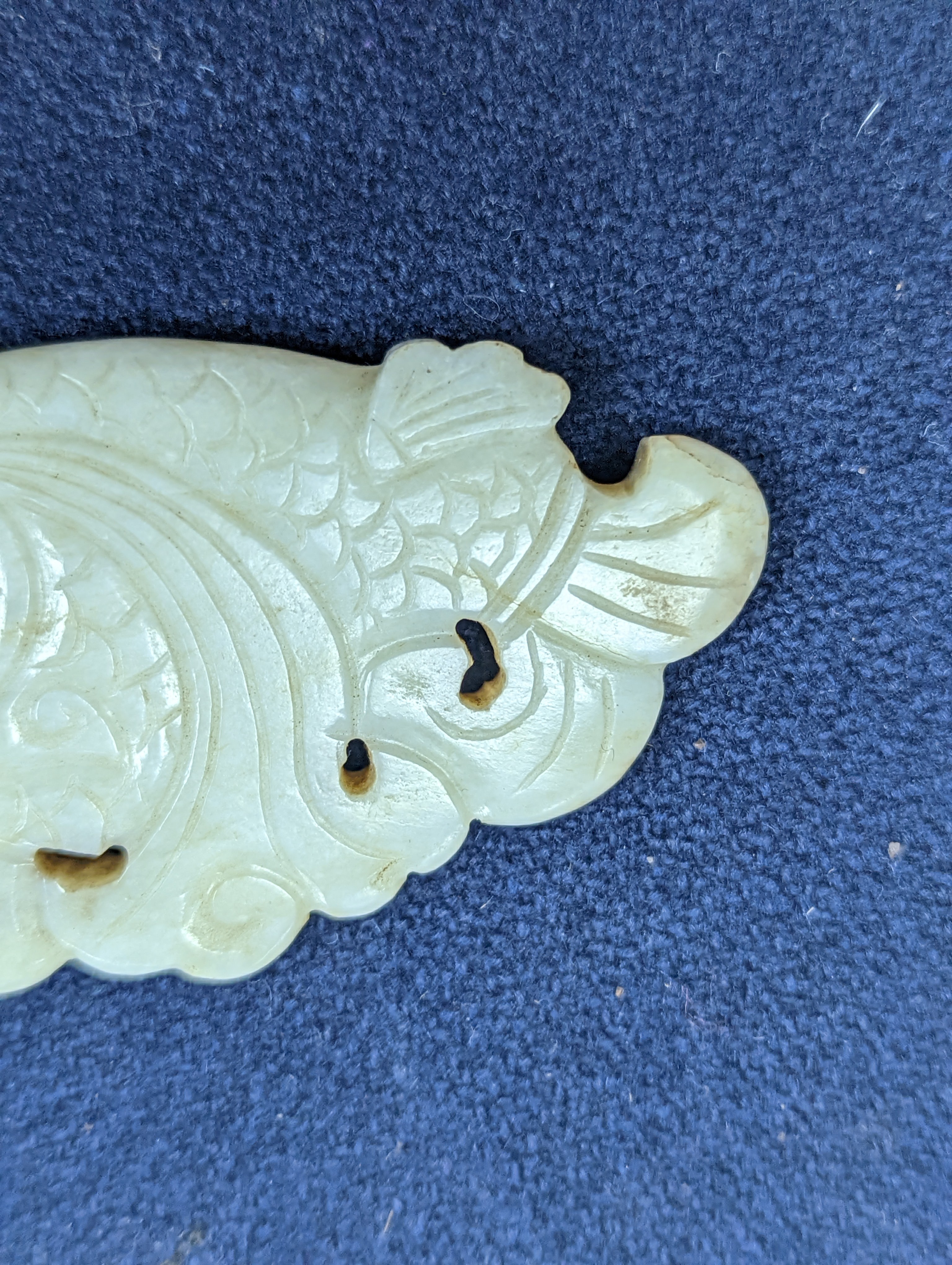 A Chinese white and black jade ‘dragon-fish’ plaque, 19th/20th century, 6cm
